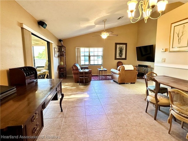 living area featuring lofted ceiling, light tile patterned flooring, ceiling fan with notable chandelier, and a wealth of natural light
