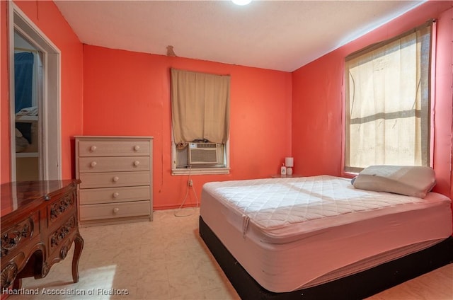 bedroom featuring light floors and cooling unit