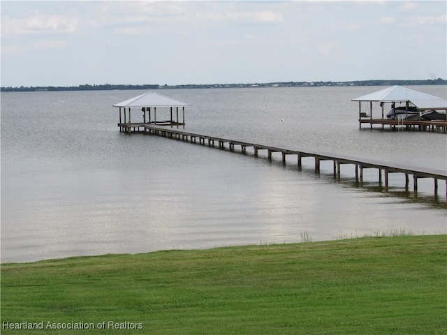 3955 Placid Dr, Lake Placid, FL 33852 - dock with a water view, a yard, and boat lift