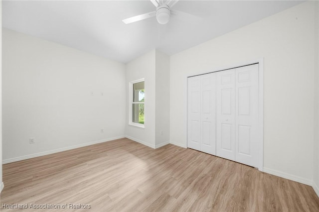 unfurnished bedroom featuring ceiling fan, light hardwood / wood-style floors, and a closet