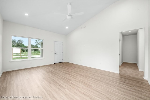 spare room featuring ceiling fan, light hardwood / wood-style flooring, and high vaulted ceiling