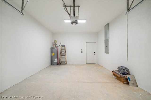 garage with electric panel, a garage door opener, and water heater