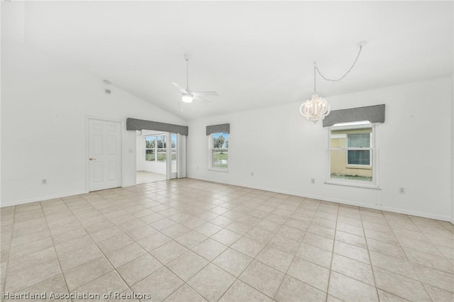 tiled spare room with ceiling fan with notable chandelier and lofted ceiling