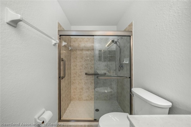 bathroom featuring walk in shower and toilet