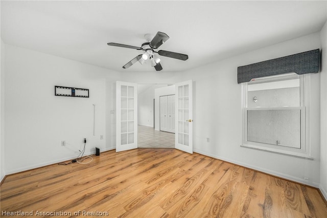 unfurnished room featuring french doors, light hardwood / wood-style flooring, and ceiling fan