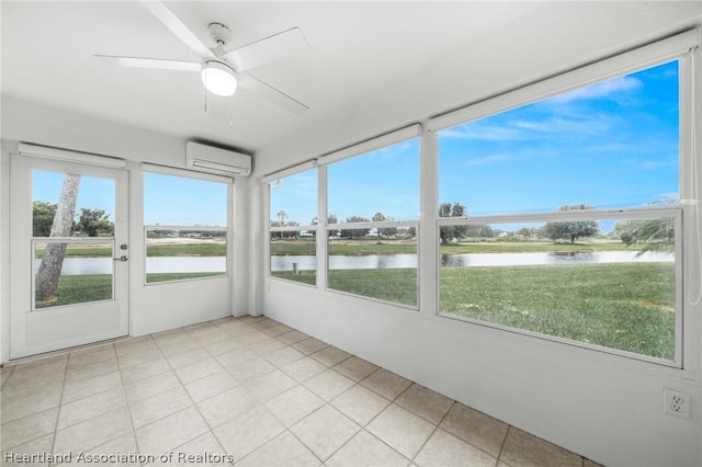 unfurnished sunroom featuring ceiling fan, a healthy amount of sunlight, a water view, and an AC wall unit