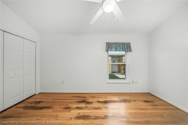 unfurnished bedroom featuring a closet, ceiling fan, and hardwood / wood-style flooring