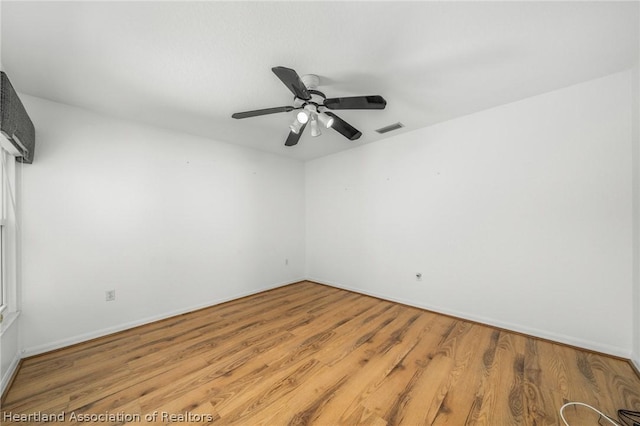 empty room featuring ceiling fan and light hardwood / wood-style flooring