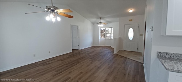 entrance foyer with ceiling fan, dark wood-type flooring, and vaulted ceiling