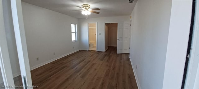 unfurnished bedroom featuring connected bathroom, ceiling fan, and dark hardwood / wood-style flooring