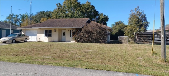 view of front of house with a front yard and a garage