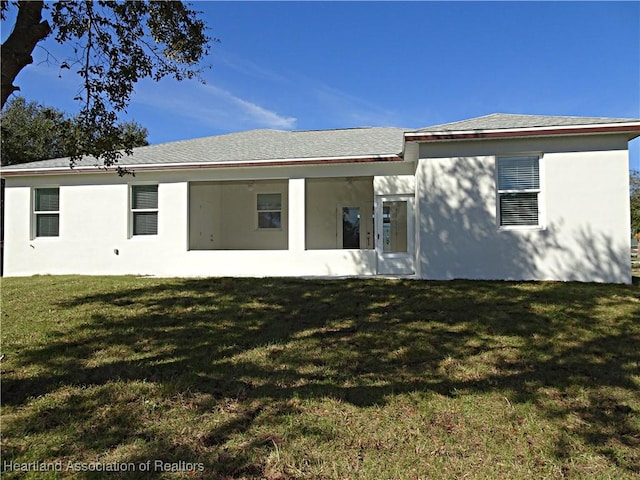 back of house featuring a lawn