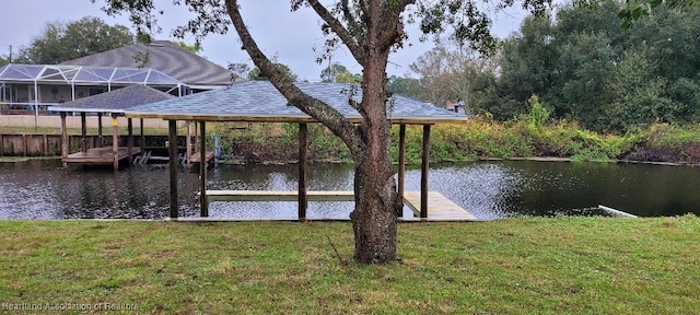 dock area with a water view and a yard