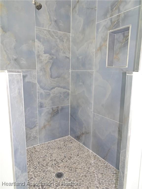 bathroom with tiled shower