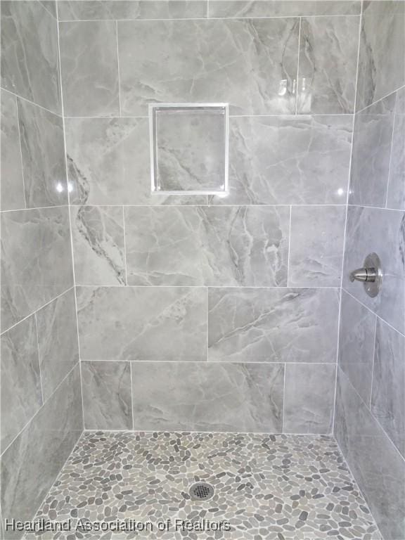 bathroom with tiled shower