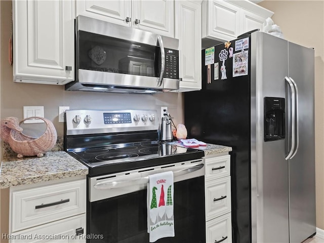 kitchen featuring light stone countertops, white cabinetry, and stainless steel appliances