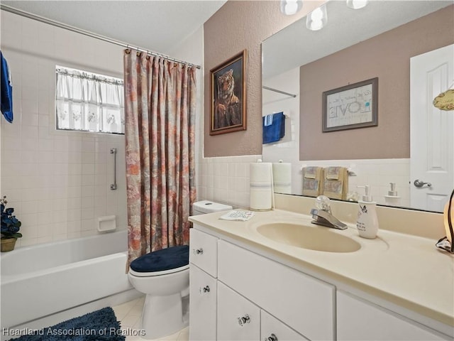 full bathroom featuring shower / tub combo with curtain, tile walls, toilet, vanity, and tile patterned floors