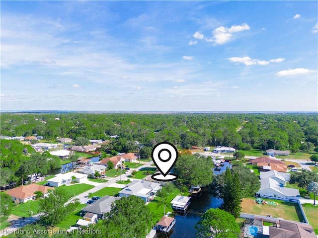 drone / aerial view with a residential view and a view of trees