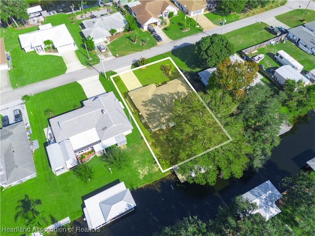 drone / aerial view with a water view and a residential view