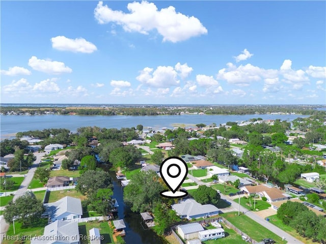 drone / aerial view featuring a residential view and a water view