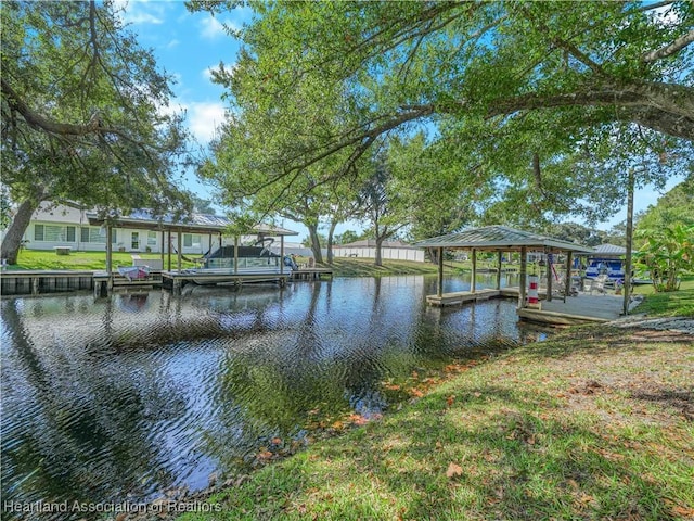 dock area with a water view and boat lift