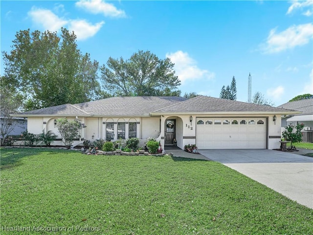 single story home featuring a garage, concrete driveway, a front lawn, and stucco siding