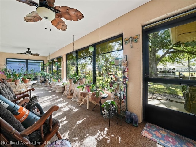 sunroom featuring a ceiling fan