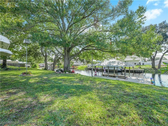 view of yard featuring a boat dock and a water view