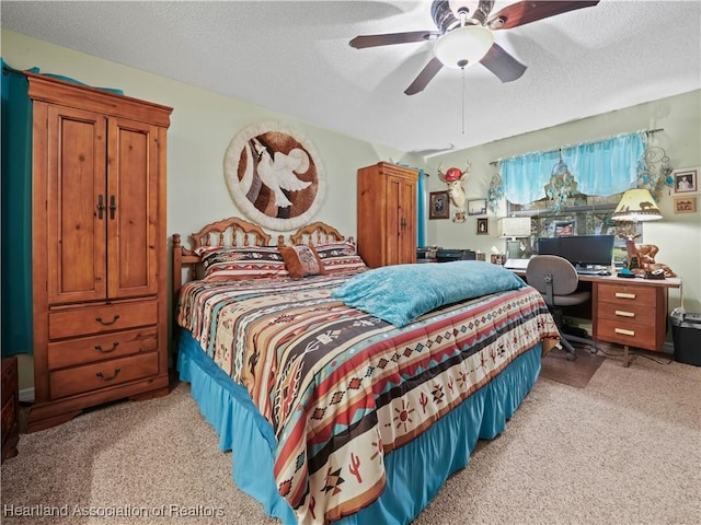 bedroom featuring ceiling fan, a textured ceiling, and light colored carpet