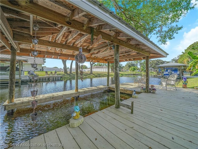 dock area with a water view and boat lift