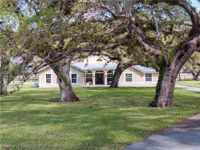 view of front of property with a front lawn and stucco siding