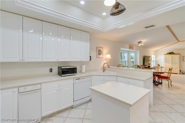 kitchen with visible vents, stainless steel microwave, ornamental molding, white dishwasher, and a sink