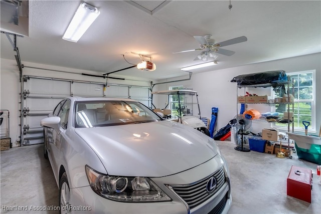 garage with a garage door opener and a ceiling fan