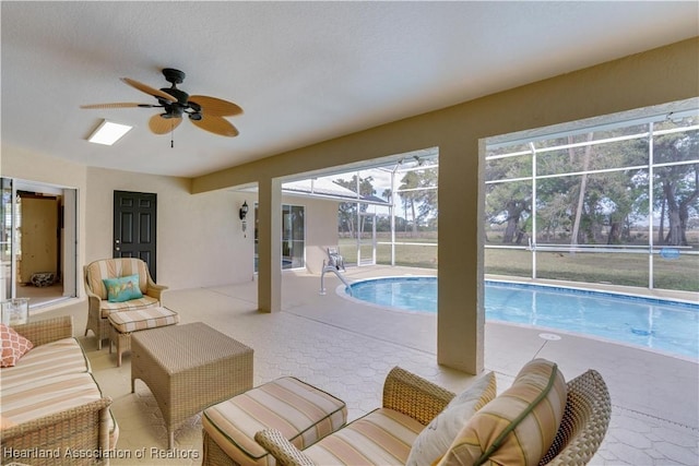 outdoor pool featuring a lanai, ceiling fan, an outdoor hangout area, and a patio