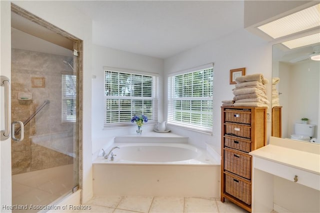 full bathroom featuring tile patterned flooring, a garden tub, a shower stall, and vanity