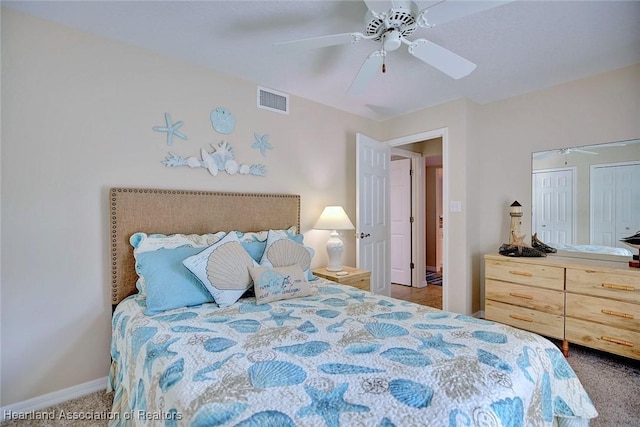 bedroom featuring dark carpet and ceiling fan