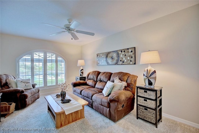 carpeted living room featuring ceiling fan