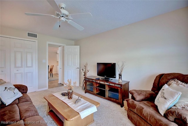 living room featuring light carpet and ceiling fan