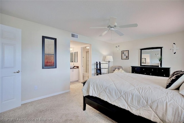 carpeted bedroom featuring ceiling fan and ensuite bathroom