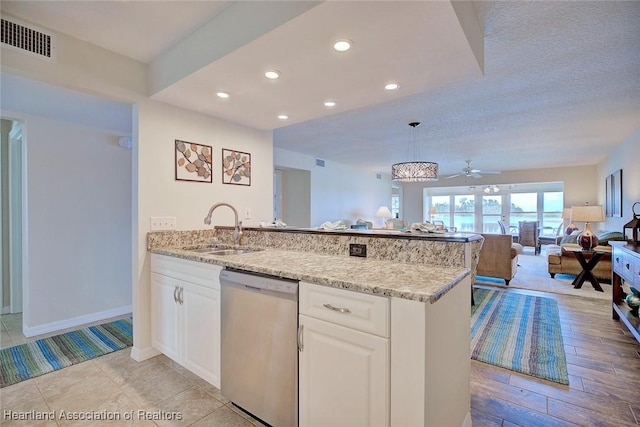 kitchen with sink, dishwasher, white cabinetry, light stone counters, and decorative light fixtures