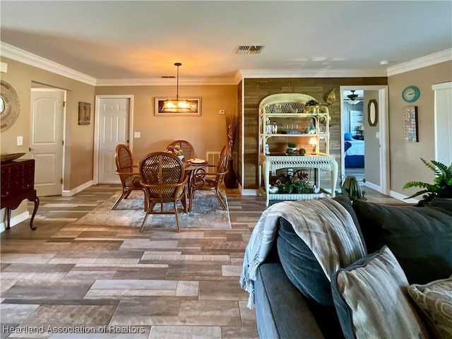 dining area featuring crown molding and hardwood / wood-style flooring