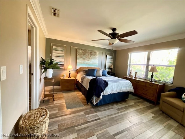 bedroom with ceiling fan, light wood-type flooring, and ornamental molding