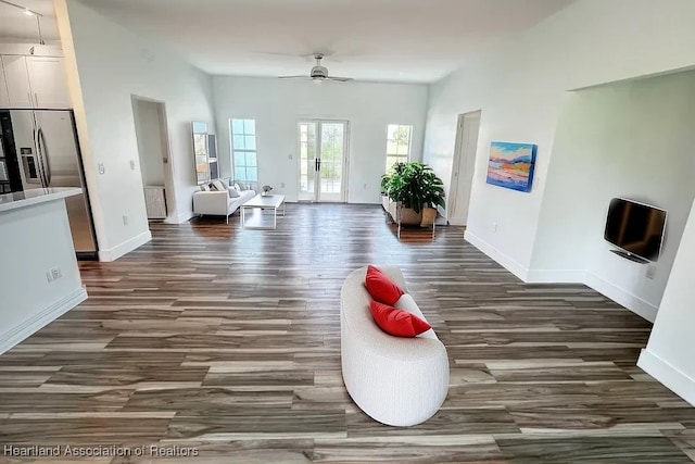 living room with dark hardwood / wood-style floors, ceiling fan, radiator heating unit, and french doors