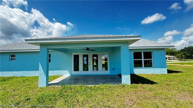 back of house featuring a lawn, ceiling fan, and a patio area