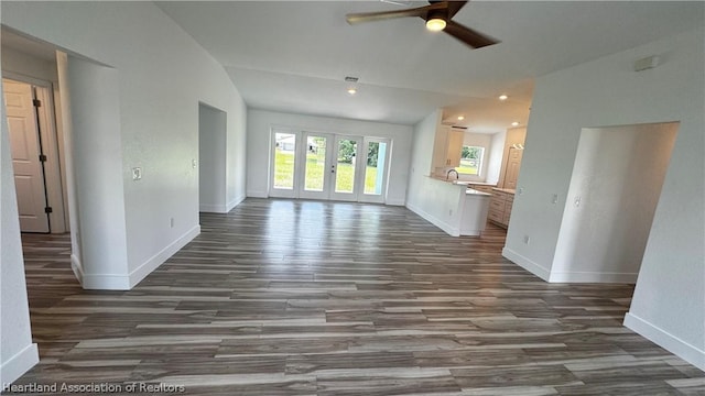 unfurnished living room with dark hardwood / wood-style flooring, ceiling fan, lofted ceiling, and sink