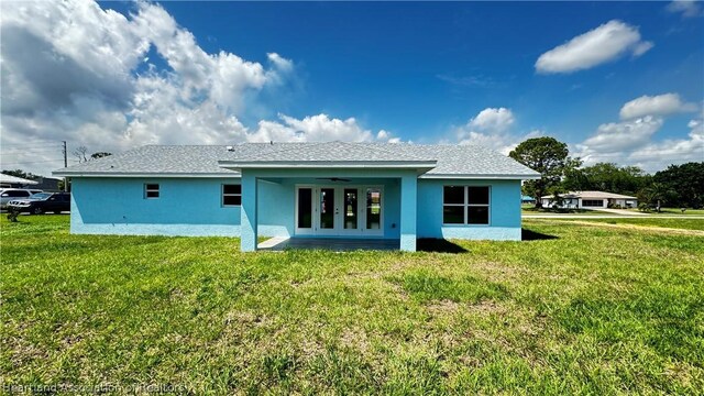 rear view of property with a yard