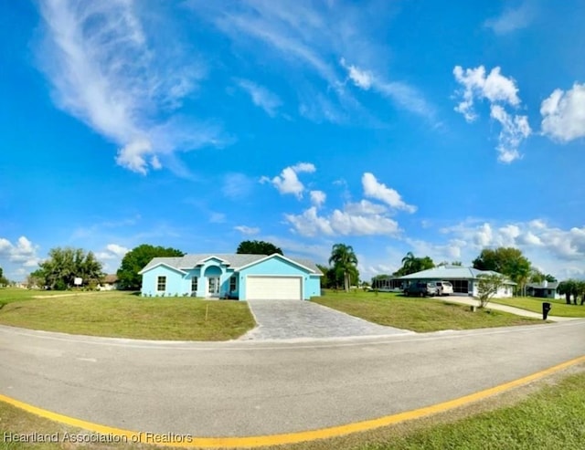 single story home with a garage and a front lawn