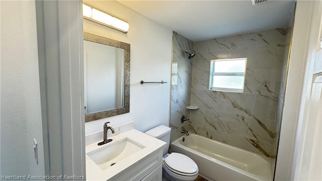 full bathroom with vanity, toilet, and tiled shower / bath