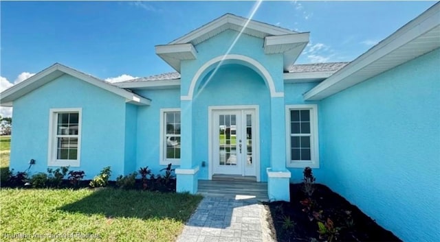 entrance to property with a lawn