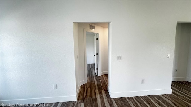 spare room featuring dark hardwood / wood-style floors